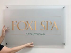 Custom acrylic sign with gold lettering printed by Overflow Print, Foxi Spa