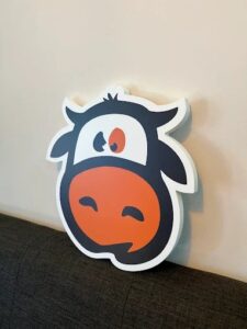 Custom die-cut PVC sign (cow mascot) printed by Overflow Print